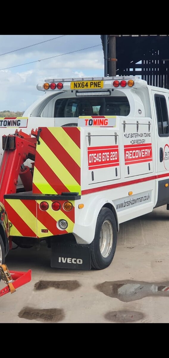 Rear of the Breakdown Man Iveco recovery truck showing 24/7 flat battery, van towing and car recovery branding with phone number 07549 676 220