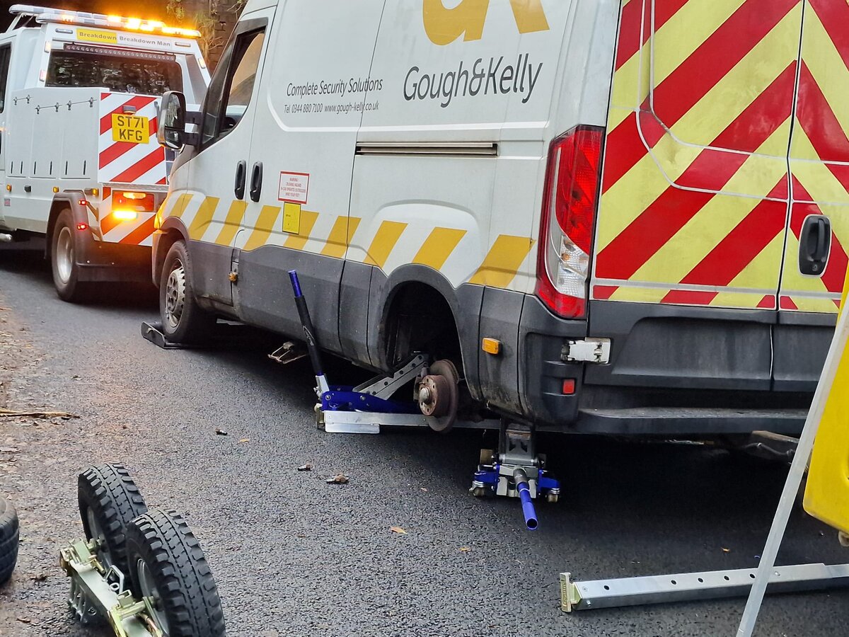 Gough & Kelly Iveco security van being lifted onto recovery dollies by Breakdown Man's rig at night.