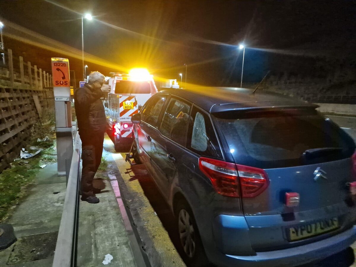 Night-time motorway recovery — Simon attending a Citroen by an SOS emergency phone.