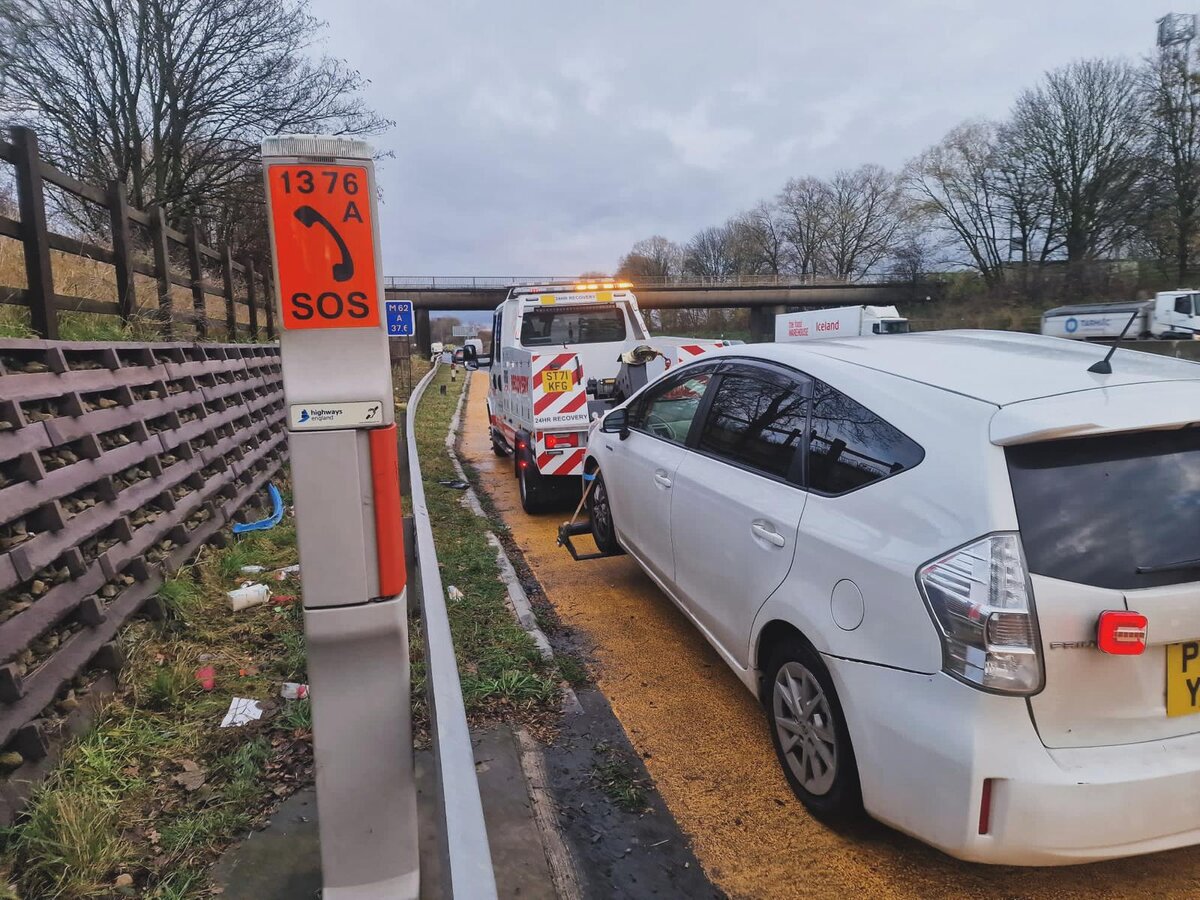 White Toyota Prius hooked up to Breakdown Man's recovery truck at SOS marker 1376A on the M62 hard shoulder.